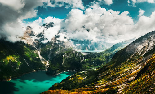 Scenic view of mountains against cloudy sky