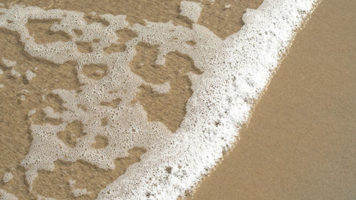 High angle view of bubbles on sand