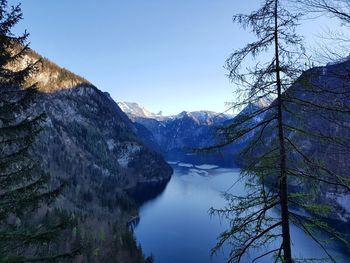 Scenic view of lake by mountains against sky