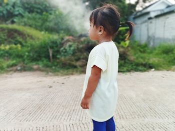 Side view of boy standing on street