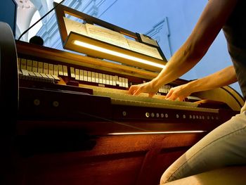 Low angle view of person playing piano