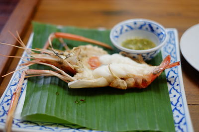 Close-up of serving food in plate on table