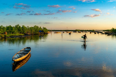 Scenic view of lake against sky during sunset