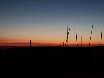 Silhouette landscape against clear sky during sunset