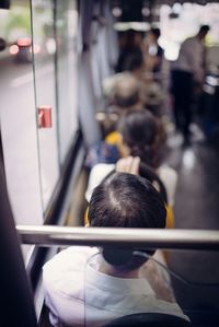 Rear view of people travelling in bus