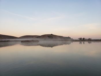 Scenic view of lake against sky during sunset