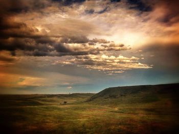 Scenic view of landscape against cloudy sky