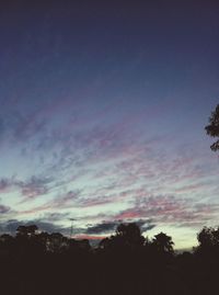 Silhouette trees against sky at sunset