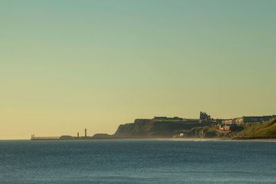 Scenic view of sea against clear sky during sunset