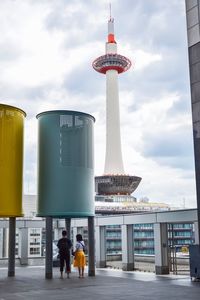 People in front of building against sky