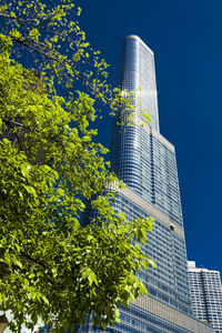 Low angle view of modern building against cloudy sky