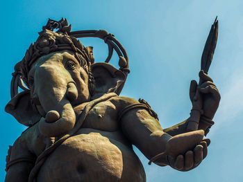 Low angle view of statue against clear blue sky