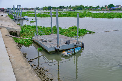Sailboats moored on lake