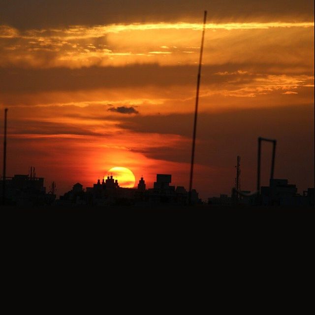 sunset, silhouette, orange color, sky, beauty in nature, scenics, cloud - sky, tranquility, tranquil scene, nature, idyllic, dramatic sky, dark, cloud, sun, outdoors, moody sky, electricity pylon, no people, street light