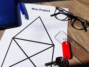 High angle view of eyeglasses and paper on table