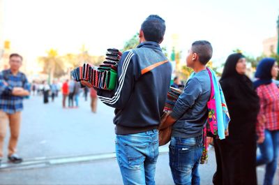 Rear view of people walking in city