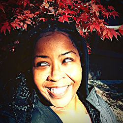 Portrait of smiling woman with autumn leaves