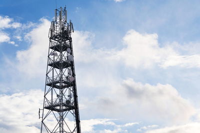 Low angle view of communications tower against sky