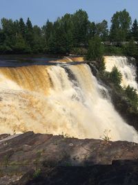 Scenic view of river flowing through rocks