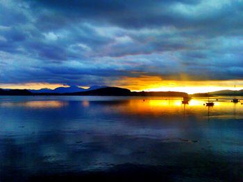 Scenic view of lake against cloudy sky