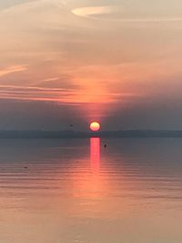 Scenic view of sea against romantic sky at sunset