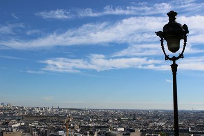 View of cityscape against cloudy sky