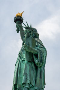 Low angle view of statue against cloudy sky