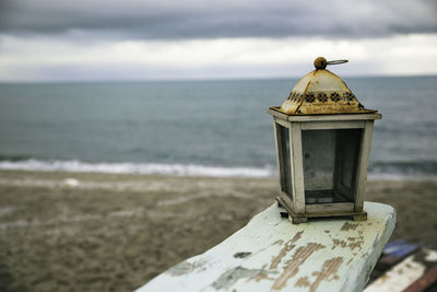 Close-up of lifeguard hut at beach against sky