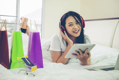 Portrait of smiling young woman using mobile phone