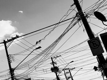 Low angle view of electricity pylon against sky