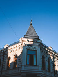 Low angle view of building against clear blue sky