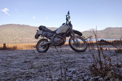 Motorcycle on field against sky