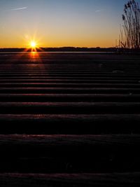 Scenic view of field against sky during sunset