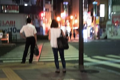 Rear view of man walking on city street