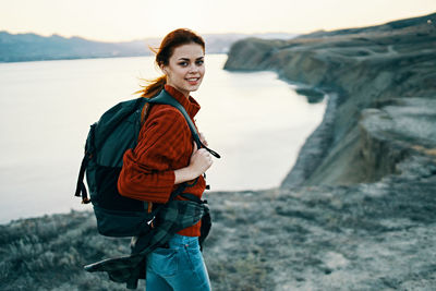 Portrait of smiling young woman standing outdoors