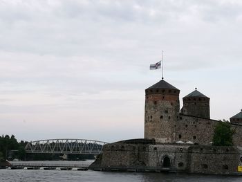 View of bridge over river against cloudy sky