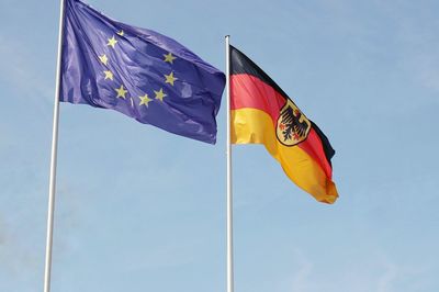 Low angle view of flags waving against sky