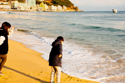 Rear view of a man standing on beach