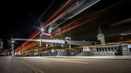 Light trails on road in city at night