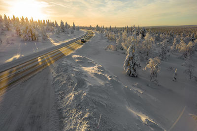 Last rays of sunlight reflecting on a road in finnish lapland