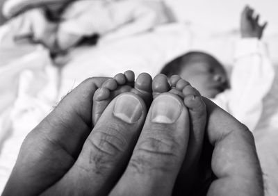 Close-up of baby holding hands