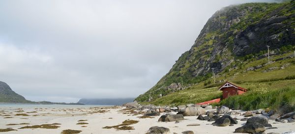 Scenic view of sea by cliff against sky