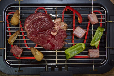 High angle view of meat on barbecue grill