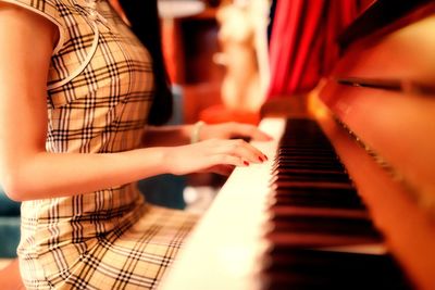 Close-up of hands playing piano