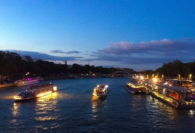 Boats in river at dusk