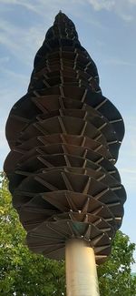 Low angle view of stack on field against sky