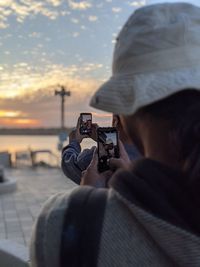 Rear view of man photographing camera