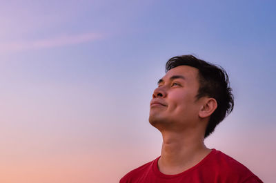 Asian man looking up to sky. positive mental health and emotion face expression.