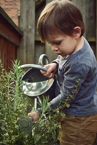 Boy standing by plants