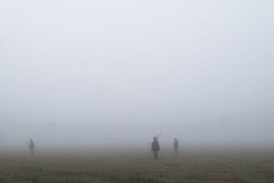 Men on field against sky